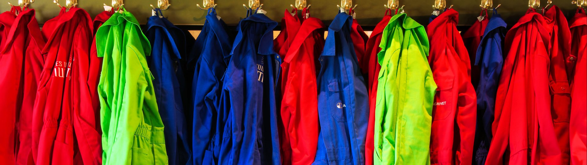 Overalls in verschillende kleuren en maten aan een kapstok