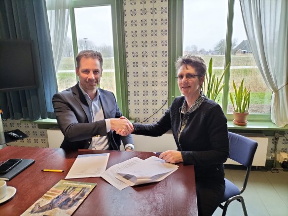 Directeur FLM Peter Wester en interim-directeur KFPS Mechteld van der Kooi schudden elkaar de hand ter bevestiging van het partnerschap